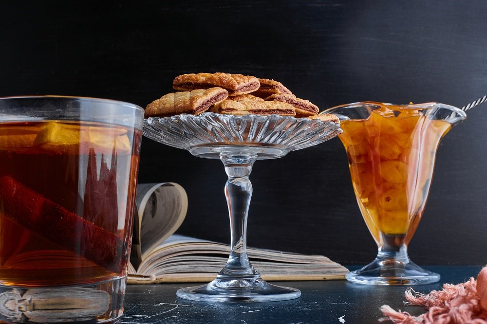 A cup of tea with cherry confiture and crackers. High quality photo